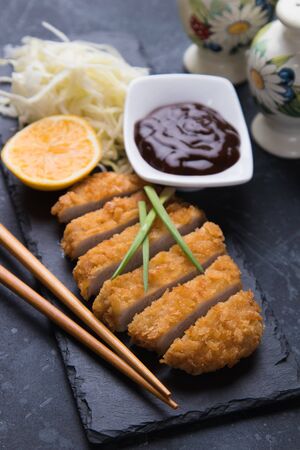 Japanese tonkatsu steak, breaded and fried pork cutlet served with shredded cabbageの写真素材