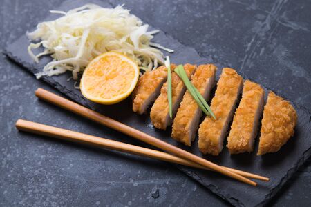 Japanese tonkatsu steak, breaded and fried pork cutlet served with shredded cabbageの写真素材