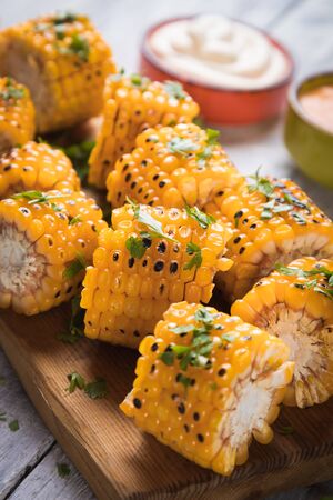 Sweet corn slices grilled and spiced as healthy party food alternativeの写真素材