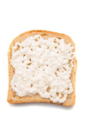 Slice of bread with spread on top isolated over white backgroundの写真素材