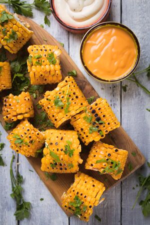 Sweet corn slices grilled and spiced as healthy party food alternativeの写真素材