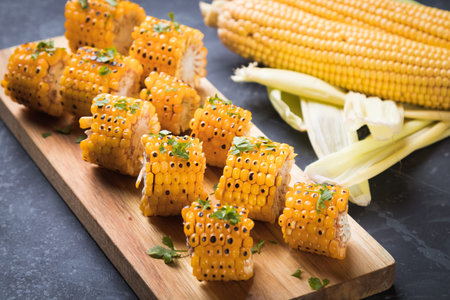 Sweet corn slices grilled and spiced as healthy party food alternative