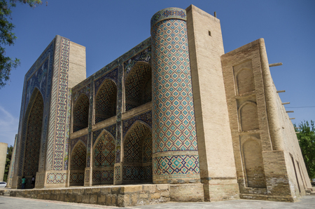 The facade of Nadir Divan-Beghi madrasah is decorated with multicolored majolica with a predominance of blue tones, Bukhara, Uzbekistan.のeditorial素材