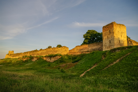 A view of the medieval Izborsk fortress walls and towers in sunset, Pskov region,Russiaのeditorial素材