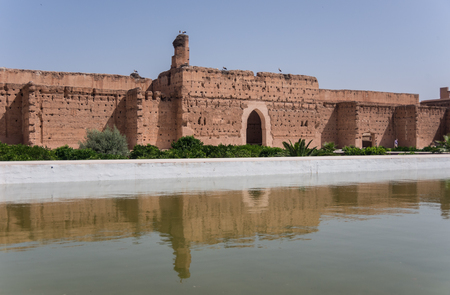 Wall's reflection in pool of El Badi Palace or Palais El Badii in Marrakech, Moroccoのeditorial素材