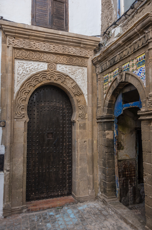 Narrow street, old doors and colorful old houses of medieval medina of Essaouira, Moroccoの写真素材
