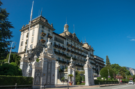Stresa,Lake Maggiore,Italy-August 30,2018 : Grand Hotel Des Iles Borromees and Stresa town embankment, view from lake.のeditorial素材