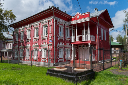 Vologda, Russia - July 28, 2019: Old red wooden house with carved windows in Gogol Street, Vologda city (Russia)のeditorial素材