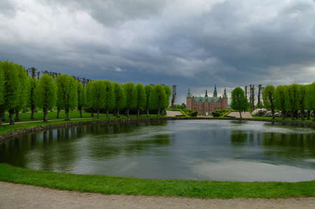 Hillerod, Denmark - 1 May 2011: Renaissance Frederiksborg Castle on the island. Pond in Castle's garden on foreground.のeditorial素材