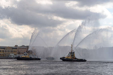 St. Petersburg, Russia - May 2, 2021: Harbor tugs perform the Tug Waltz show during the Icebreaker Festival on the Neva Riverのeditorial素材