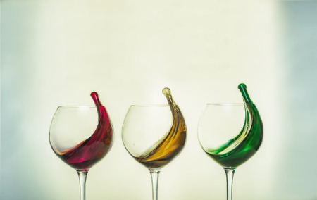 Three glasses with colorful drinks red, yellow, greenの写真素材