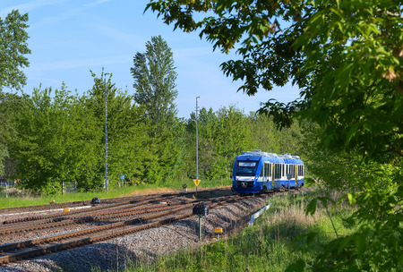 Beautiful express train, races by rail summer morningの写真素材