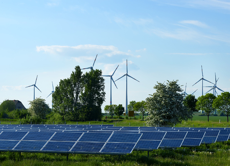 Production of alternative energy, solar panels and wind generators, in summerの写真素材