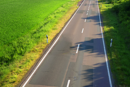 Asphalt road with a marking, in the countrysideの写真素材