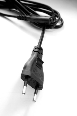 Black-and-white photo of an electricity cable with a plug