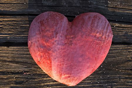 Gingerbread heart for x-mas on an old wooden tableの写真素材
