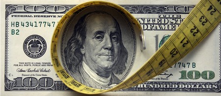 Finance/Investment Concept/Creative photo about financial crisise. Measuring tape over moneyの写真素材