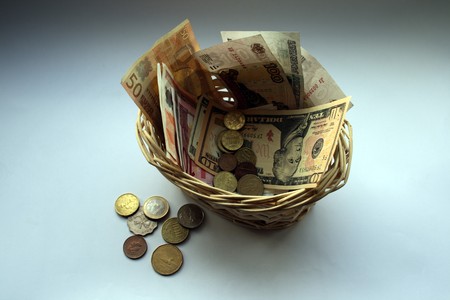 Busines concert about saving money: varios banknotes and coins in the basket like sibol of constantlyの写真素材