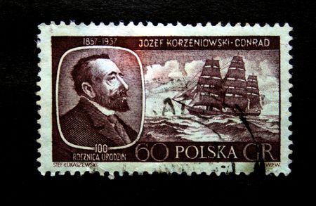 A stamp printed in Poland shows Josef Korzeniowski-Conrad on the bacground of Sailing vessel circa 1950sの写真素材