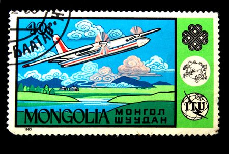 A stamp printed by the Mongolia shows a jet above earth,  circa 1983.の写真素材