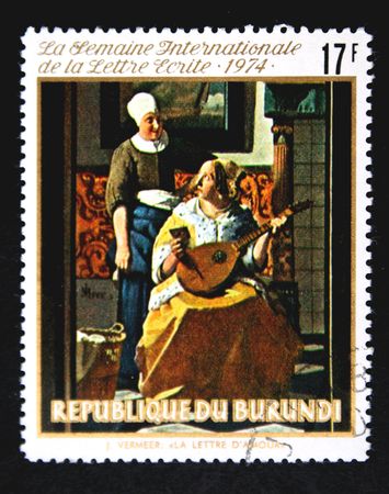 A stamp printed in Burundi shows paint "Letter of love" by artist Johannes Vermeer, one stamp from series, circa 1974の写真素材