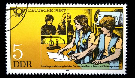 A stamp printed in GDR shows student practice on post office, one stamp from series devoted Training of the personnel for German Post, circa 1981の写真素材