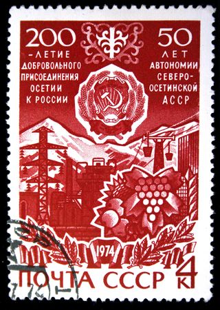 A stamp printed in tne USSR devoted 50 years of North Ossetian Autonomous Soviet Socialist Republic and 200 years of included to Russian Empire, stamp from series, circa 1973の写真素材