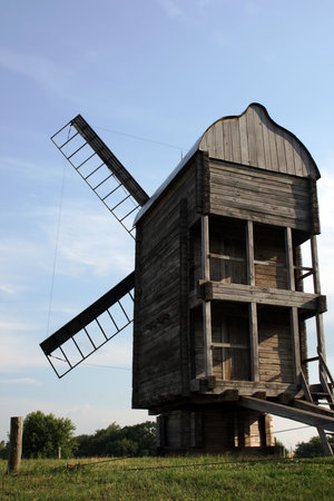  An old traditional windmill with wooden sails 