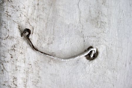 Rusty hook on an old wooden doorの写真素材
