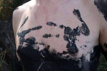 young man's chest  covered with mud in the salty lake, the town of Saki, Crimea, Ukraineの写真素材