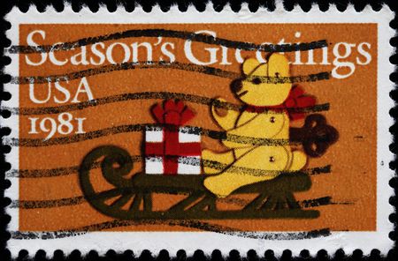 UNITED STATES - CIRCA 1981 : A stamp printed in United States. Teddy Bear on Sled Christmas Issue. United States - CIRCA 1981の写真素材