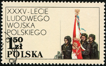 POLAND - CIRCA 1978: A stamp printed in Poland shows militaries devoted 35 years of the Polish national army, circa 1978 の写真素材