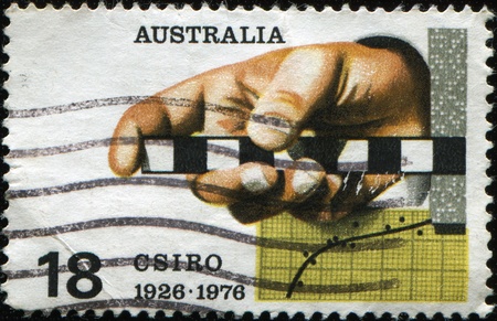 AUSTRALIA - CIRCA 1976: A stamp printed in Australia honoring 50 years of Commonwealth Scientific and Industrial Research Organisation, circa 1976のeditorial素材