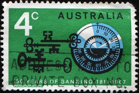 AUSTRALIA - CIRCA 1967: A stamp printed in Australia honoring 150 years of banking shows combination lock of safe, circa 1967 の写真素材