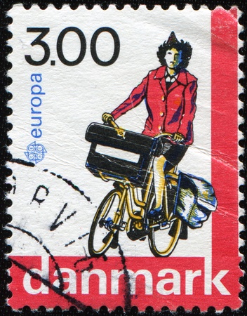 DENMARK - CIRCA 1988: A stamp printed in Denmark shows postie bike, circa 1988.の写真素材