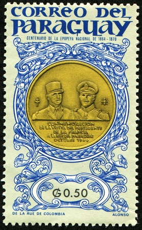 PARAGUAY - CIRCA 1970: A stamp printed in Paraguay printed to commemorate the visit of the President of France to the Republic of Paraguay in October 1960, on medal Charles de Gaulle and Alfredo Stroessnerの写真素材