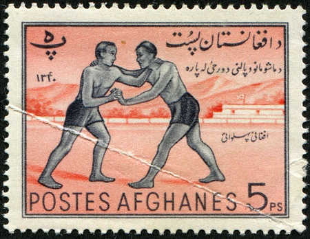 AFGHANISTAN - CIRCA 1961:  A stamp printed in Afghanistan shows wresling, circa 1961 の写真素材