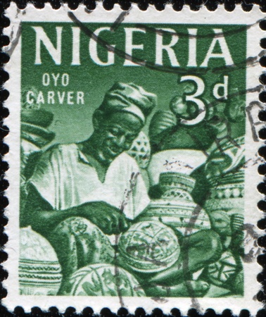 NIGERIA - CIRCA 1961: A stamp printed in Nigeria shows Oyo carver, series, circa 1961のeditorial素材