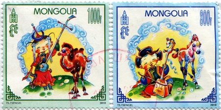MONGOLIA - CIRCA 2010: A stamp printed in Mongolia shows Girl and boy playing on the Mongolian national instrument Morin Huur, circa 2010の写真素材