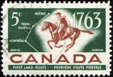 CANADA - CIRCA 1963: A stamp printed in Canada honoring Bicentiale of Quebec-Trois-Rivieres-Montreal Postal Service shows Man and horse, circa 1963の写真素材