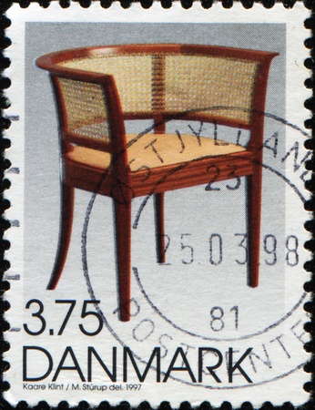 DENMARK - CIRCA 1997: A stamp printed in Denmark shows chair by Kaare Klint Danish architect and furniture designer, circa 1997の写真素材
