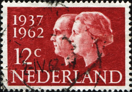NETHERLANDS - CIRCA 1962: A stamp printed in Netherlands honoring Silver Wedding shows Queen Beatrix and Prince Bernhard, circa 1962のeditorial素材
