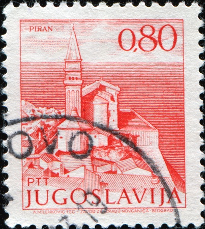 YUGOSLAVIA - CIRCA 1971: A stamp printed in Yugoslavia shows View at Piran in Slovenia at the Adriatic sea , circa 1971の写真素材