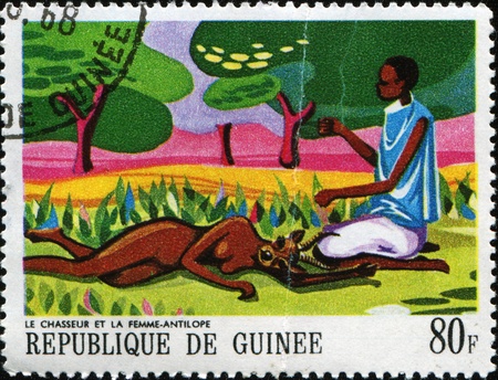 GUINEA - CIRCA 1968: A post stamp is printed in the Republic of Guinea shows Paintings of African Legends のeditorial素材