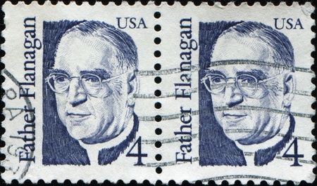 UNITED STATES OF AMERICA - CIRCA 1986: A stamp printed in the United States of America shows image of Father Edward J. Flanagan,  circa 1986 のeditorial素材