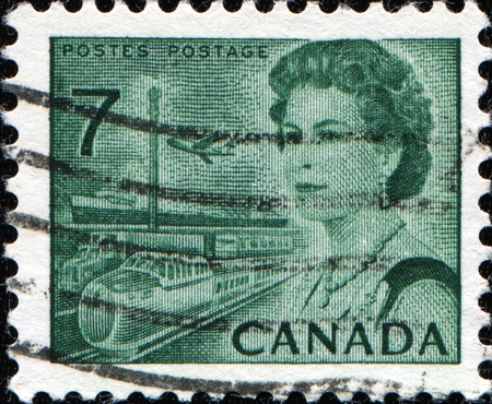 CANADA - CIRCA 1972: A stamp printed in Canada shows Queen Elizabeth II, airplane and train, circa 1972のeditorial素材