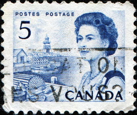CANADA - CIRCA 1967: A stamp printed in Canada shows Queen Elizabeth II against background of Harbour scene, circa 1967のeditorial素材