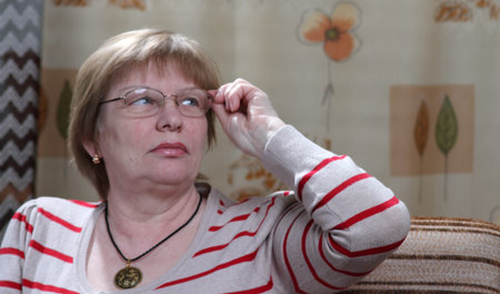 senior woman in eye glases and striped jumper
