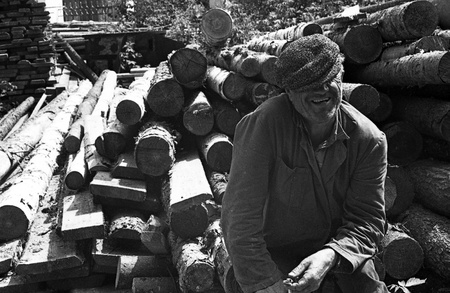 USSR - CIRCA 1979  Carpenter siting on logs, Kursk, Russia, circa 1979のeditorial素材