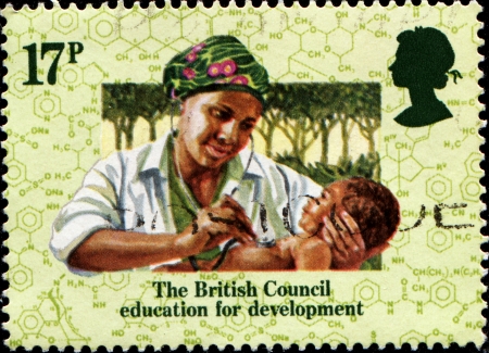 UNITED KINGDOM - CIRCA 1984  A stamp printed in United Kingdom issued for the 50th anniversary of British Council education for development shows nurse with child, circa 1984のeditorial素材